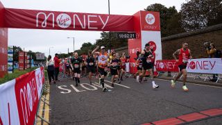 Runners as they cross the red start line of the 2021 London Marathon, Sunday 3rd October 2021.