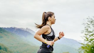 Woman runs holding an energy gel