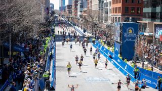 Runners approach the 2022 Boston Marathon finish line along the wide and straight Boylston Street