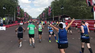 Runners in the London Marathon approach the finish line on the Mall